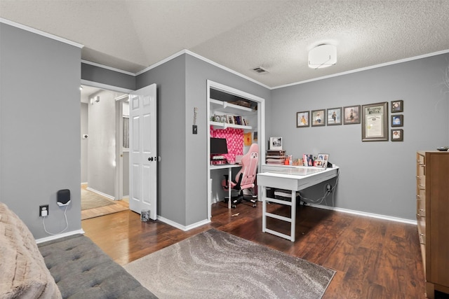 office area with dark wood-type flooring, ornamental molding, and a textured ceiling