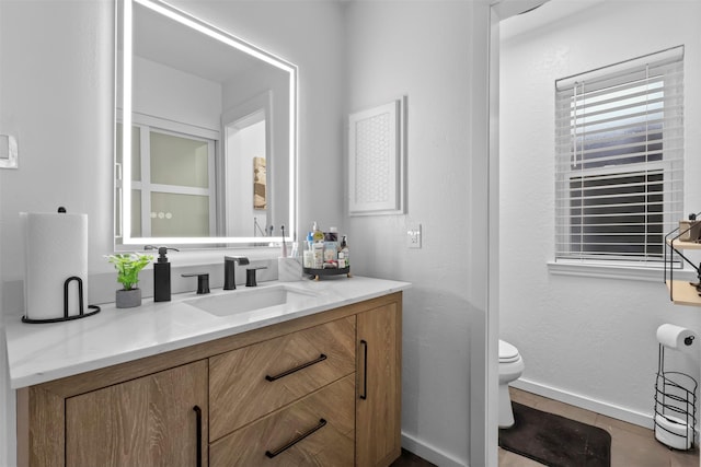 bathroom with vanity, tile patterned floors, and toilet