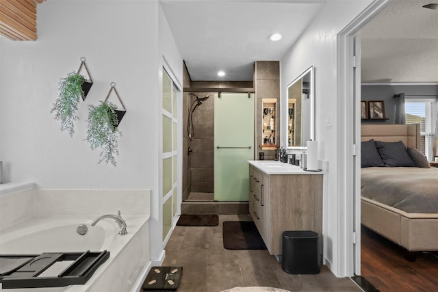 bathroom featuring vanity, independent shower and bath, and wood-type flooring