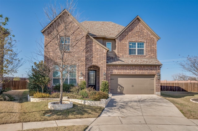 view of front of property with a garage and a front yard