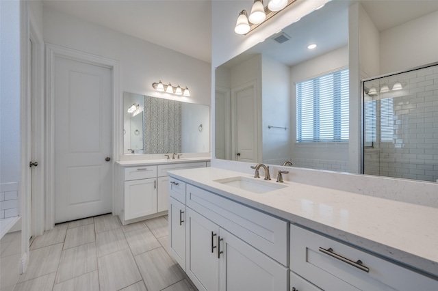 bathroom with tile patterned flooring, vanity, and an enclosed shower