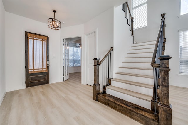 foyer entrance featuring a chandelier and light hardwood / wood-style flooring