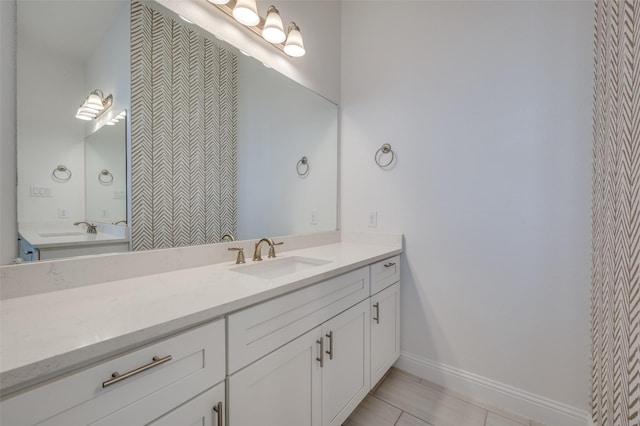 bathroom featuring tile patterned flooring and vanity