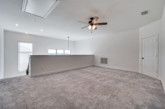 spare room featuring ceiling fan and light colored carpet