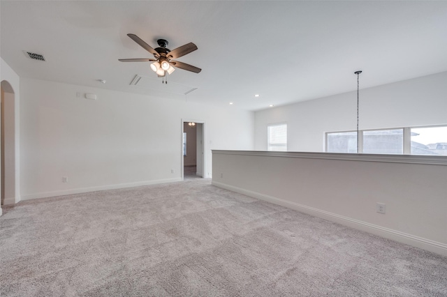 carpeted empty room featuring ceiling fan