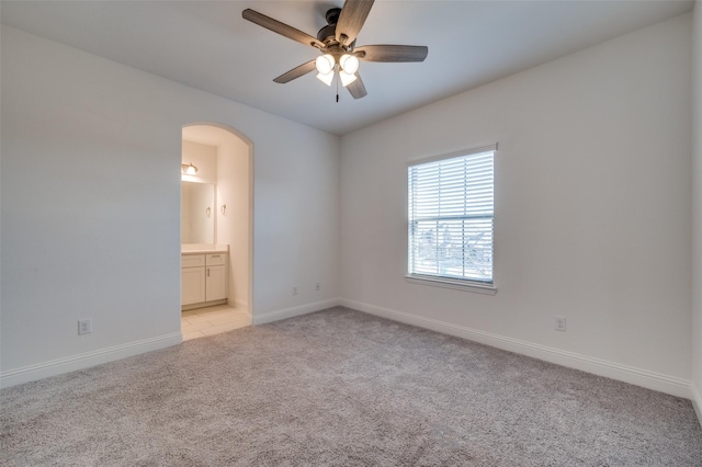 carpeted spare room with ceiling fan