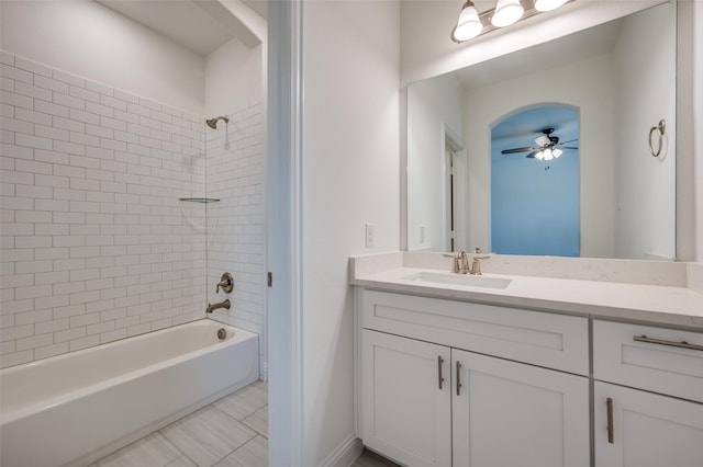 bathroom featuring tile patterned floors, vanity, tiled shower / bath combo, and ceiling fan