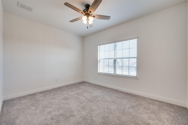 unfurnished room with ceiling fan and light carpet