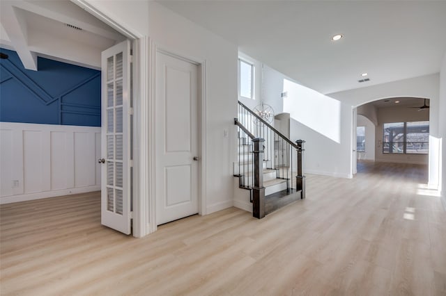 stairway featuring hardwood / wood-style flooring and ceiling fan