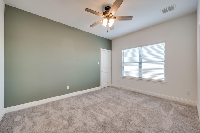 unfurnished room with light colored carpet and ceiling fan