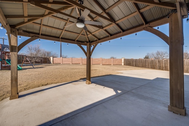 view of patio featuring a gazebo, ceiling fan, and a playground