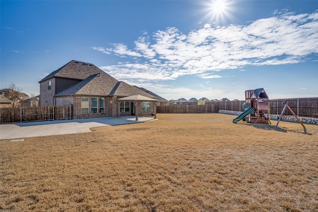 view of yard with a playground and a patio area