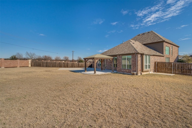 back of property with a gazebo and a patio area