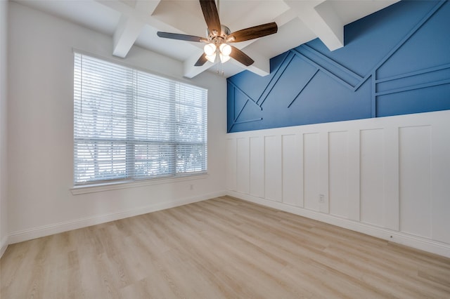 unfurnished room featuring beam ceiling, light hardwood / wood-style floors, and a wealth of natural light