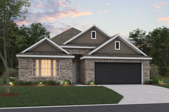 view of front facade featuring a garage and a lawn