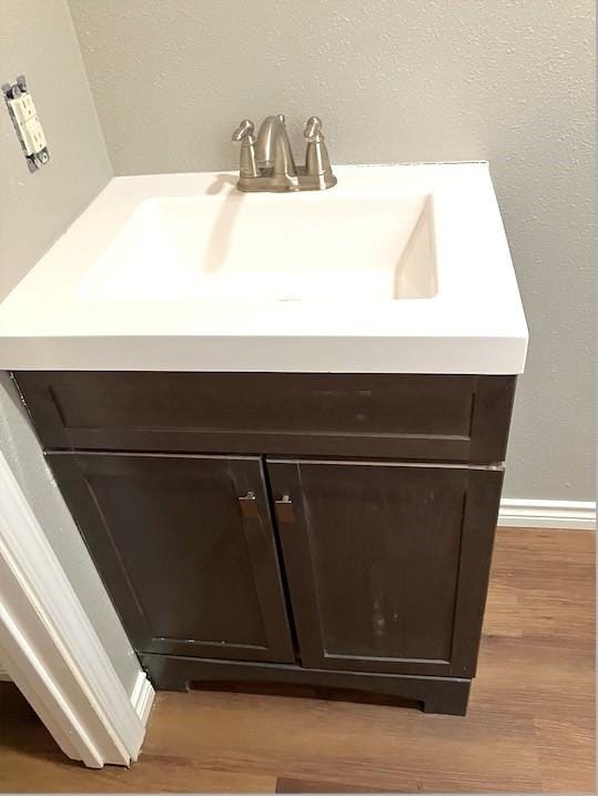 bathroom with hardwood / wood-style flooring and sink