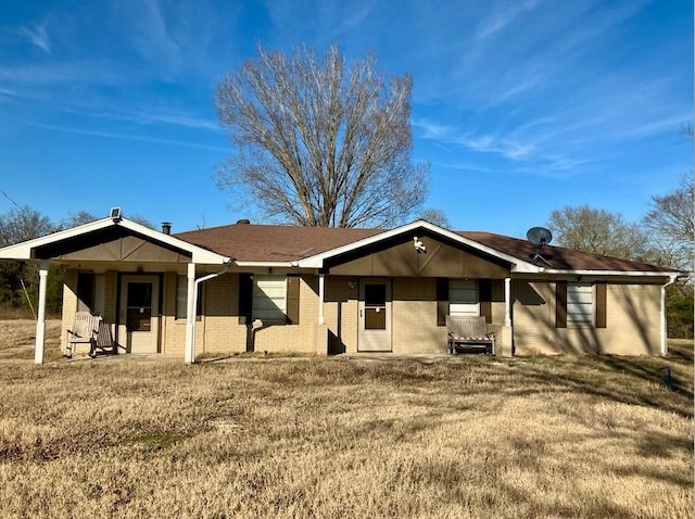 ranch-style house with a front yard and a patio