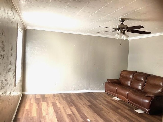 unfurnished living room with ceiling fan, hardwood / wood-style floors, and crown molding