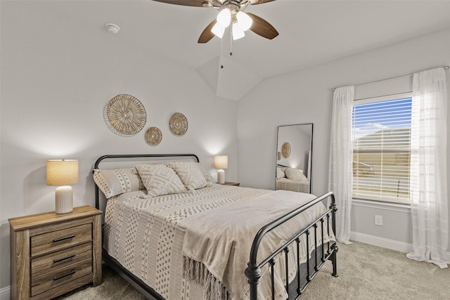 bedroom with vaulted ceiling, light colored carpet, and ceiling fan