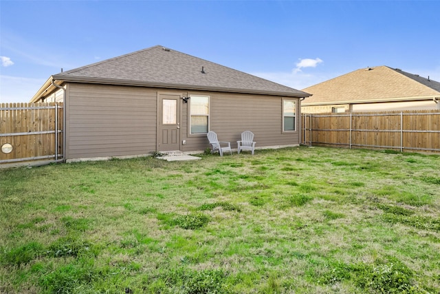 rear view of house with a yard