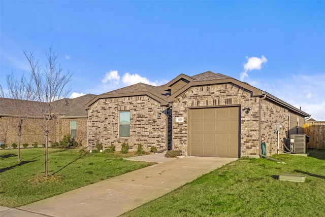 view of front of home featuring a garage, a front lawn, and central air condition unit