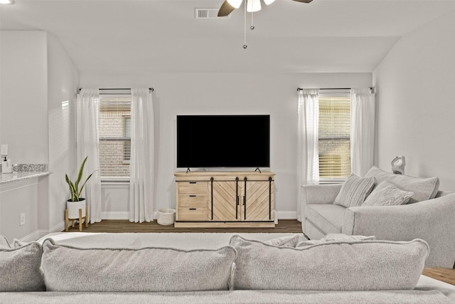 living room featuring hardwood / wood-style flooring, ceiling fan, plenty of natural light, and vaulted ceiling