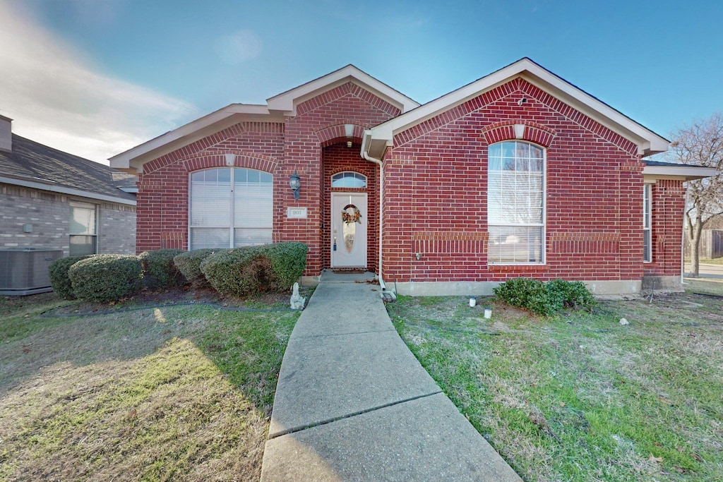 view of front facade with a front lawn and central AC unit