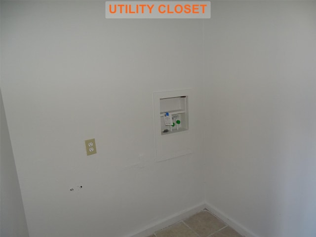 laundry room featuring light tile patterned flooring and washer hookup