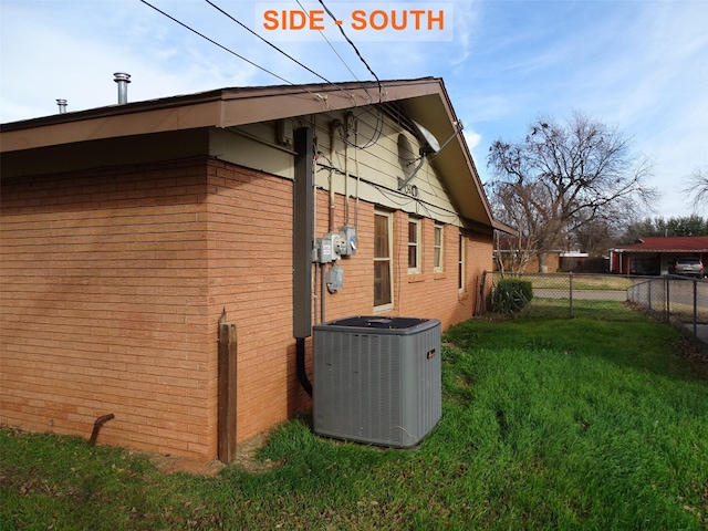 view of property exterior with a yard and central AC unit