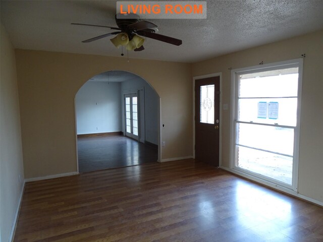 entrance foyer featuring ceiling fan, dark wood-type flooring, and a textured ceiling