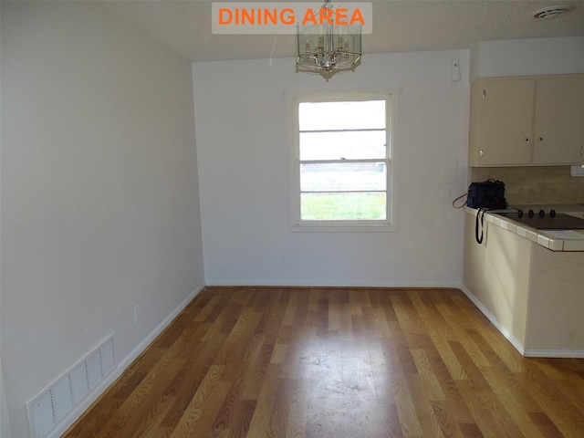 unfurnished dining area featuring light hardwood / wood-style floors