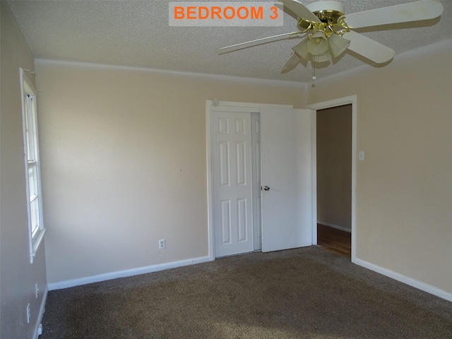 carpeted empty room featuring ceiling fan and a textured ceiling