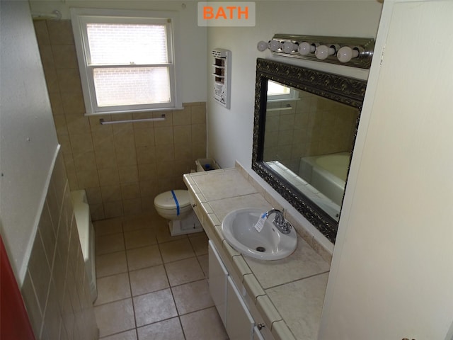 bathroom featuring tile patterned flooring, vanity, tile walls, and toilet