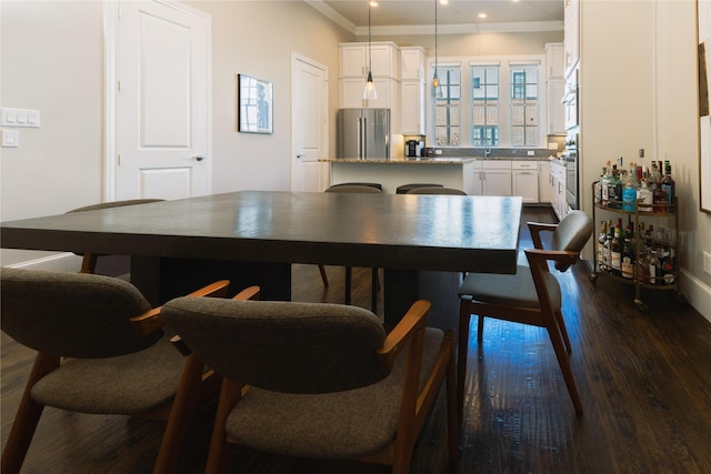 dining space with dark hardwood / wood-style flooring and crown molding