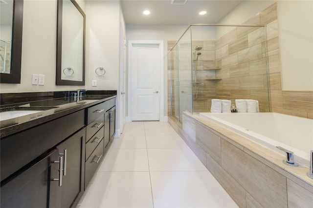 bathroom with tile patterned floors, vanity, and independent shower and bath