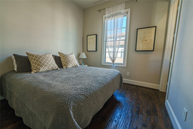 bedroom featuring dark hardwood / wood-style flooring