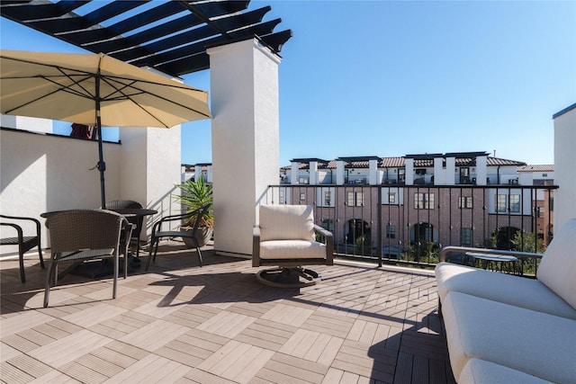 view of patio with a pergola and a balcony