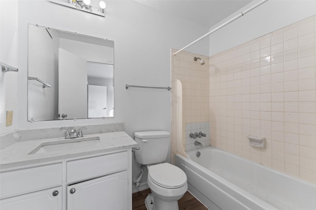 full bathroom featuring hardwood / wood-style flooring, vanity, toilet, and tiled shower / bath combo