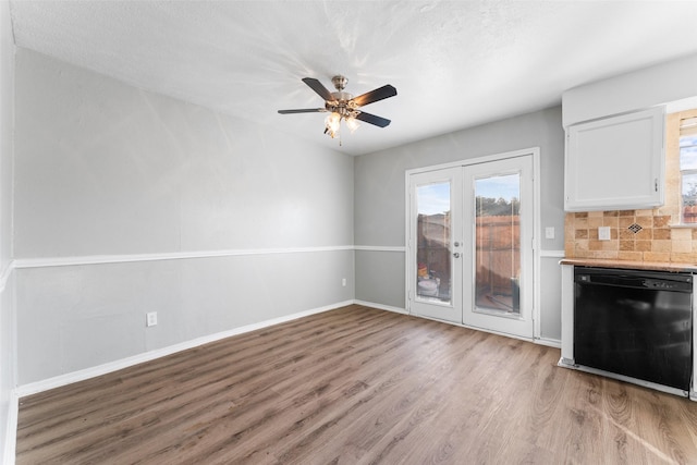 unfurnished living room featuring ceiling fan, light wood-type flooring, and french doors