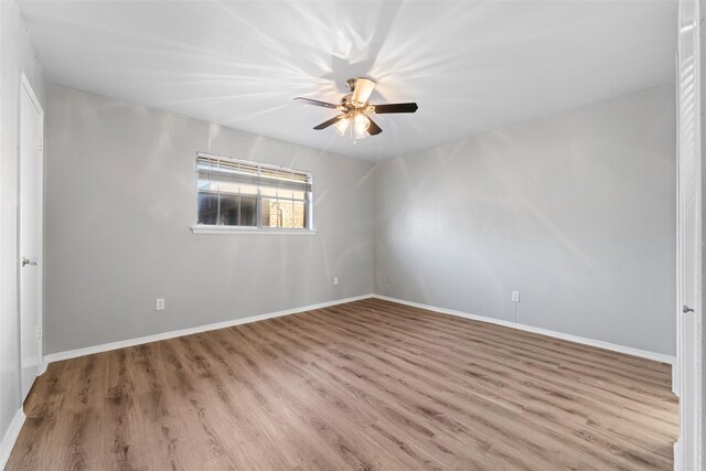 unfurnished room with ceiling fan and light wood-type flooring