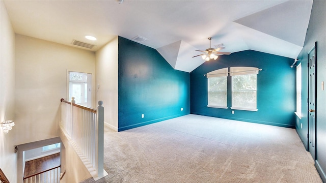 unfurnished room featuring ceiling fan, light carpet, and vaulted ceiling