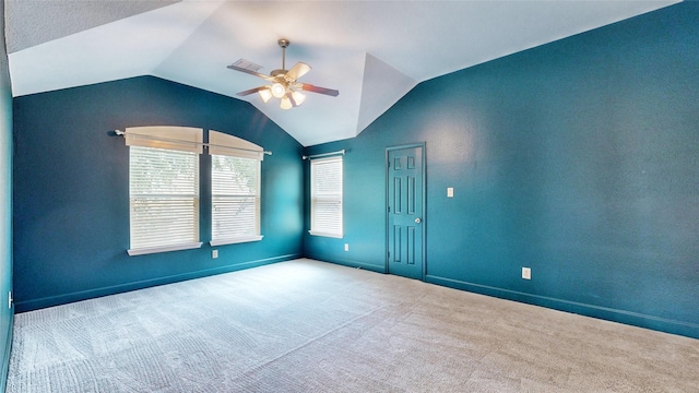 empty room with ceiling fan, light colored carpet, and lofted ceiling