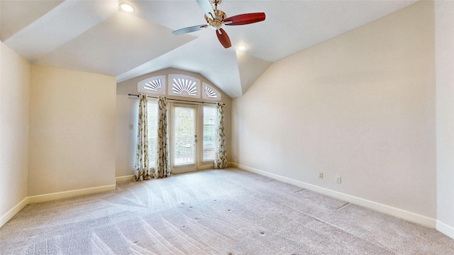 empty room featuring light colored carpet, ceiling fan, and lofted ceiling