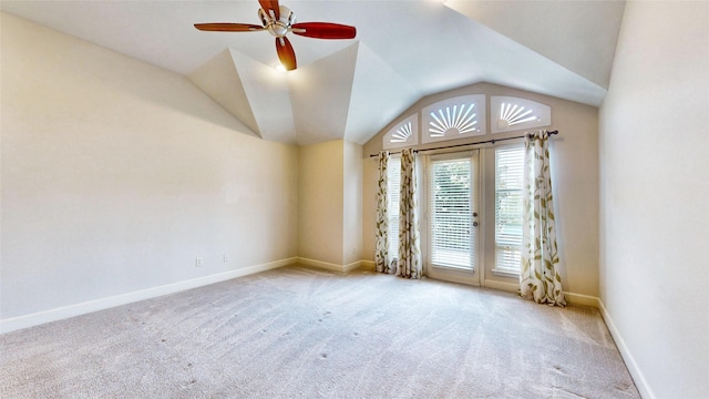 carpeted spare room with ceiling fan and lofted ceiling