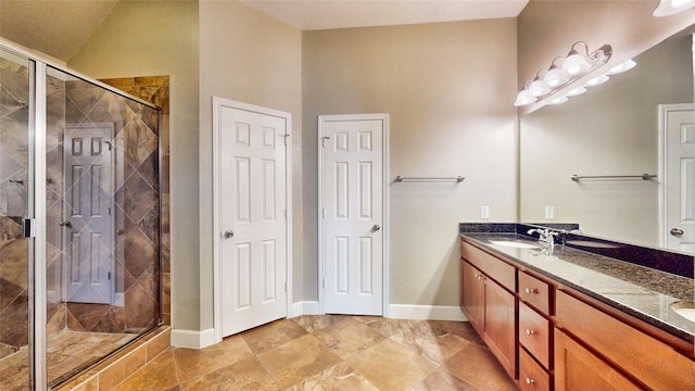 bathroom featuring vanity and a shower with shower door