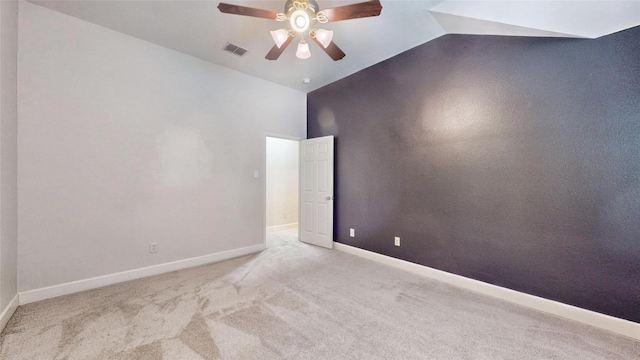 carpeted spare room featuring ceiling fan and lofted ceiling