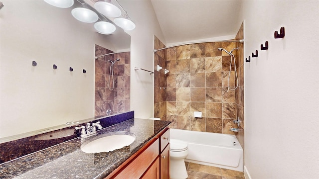 full bathroom with tiled shower / bath, vanity, and toilet