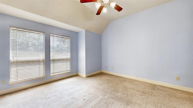 carpeted spare room featuring ceiling fan and lofted ceiling