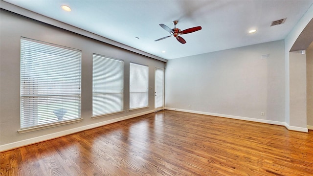 empty room with ceiling fan and hardwood / wood-style flooring