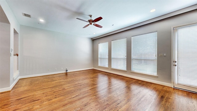 empty room with ceiling fan and light wood-type flooring